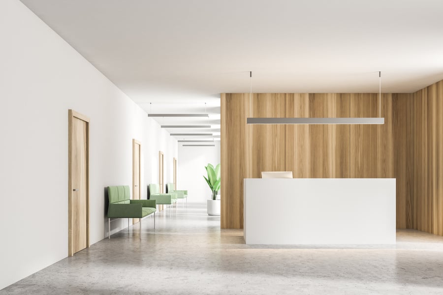 White reception counter in wooden office lobby